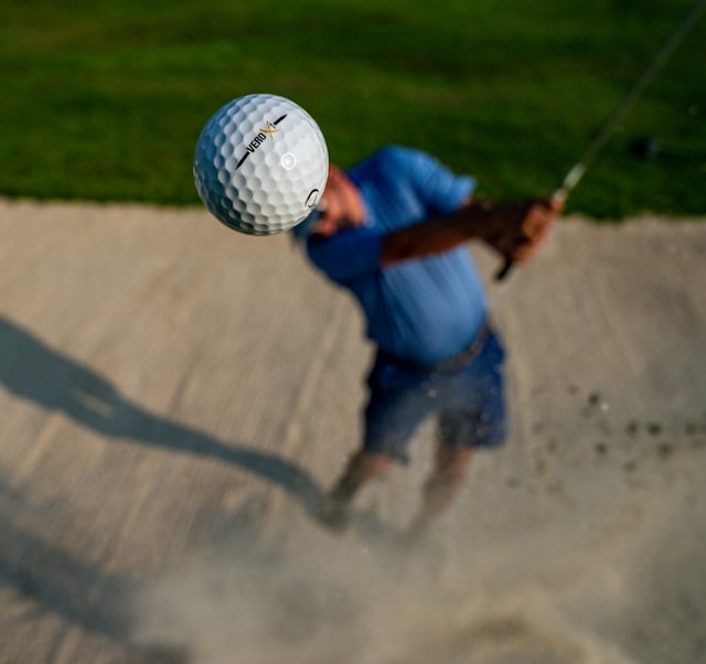 golfer hitting a golf ball toward the camera
